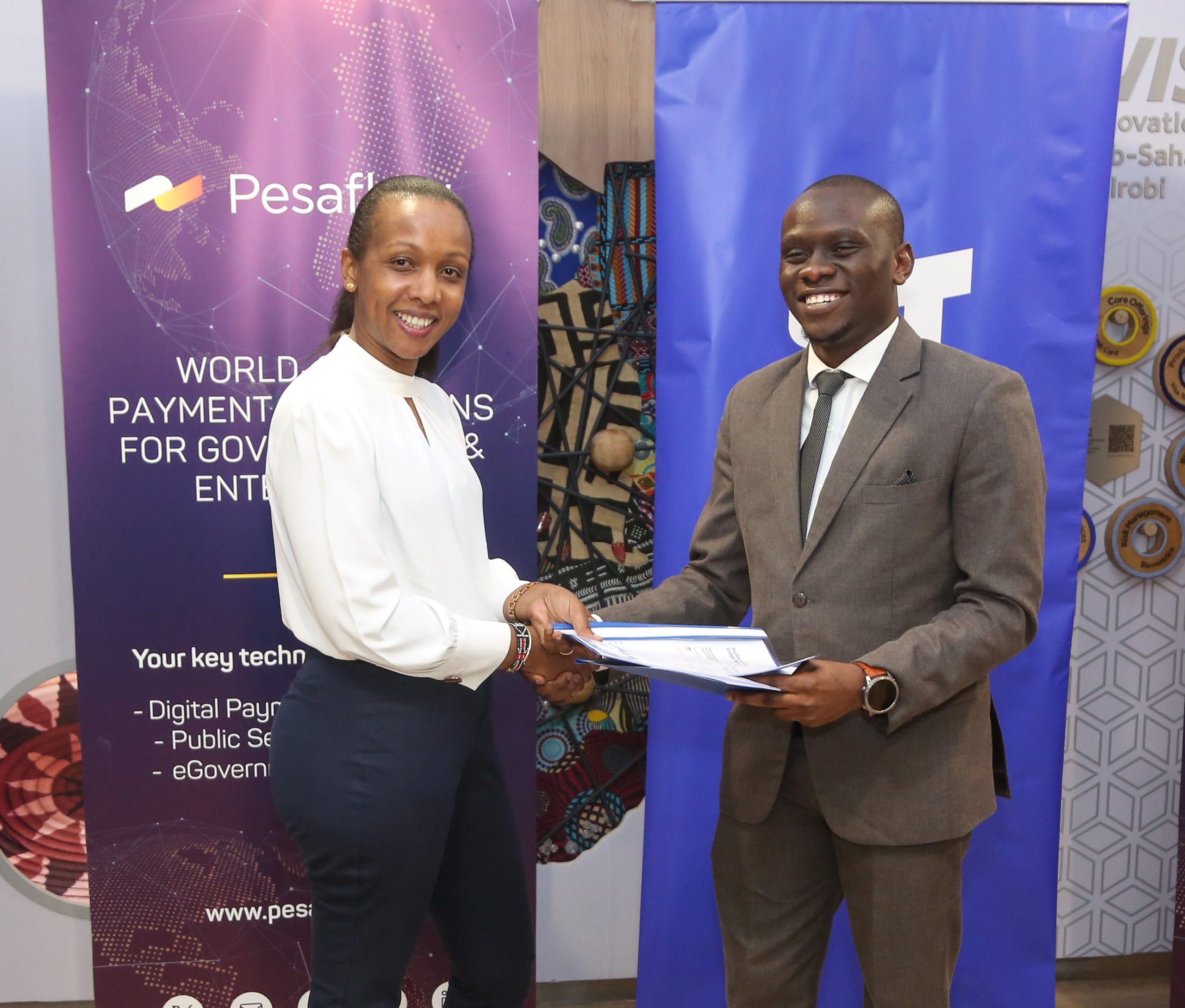 Visa Kenya Country Manager, Eva Ngigi-Sarwari and Pesaflow CEO, Evid Sibi during the strategic partnership signing ceremony between Visa and Pesaflow.