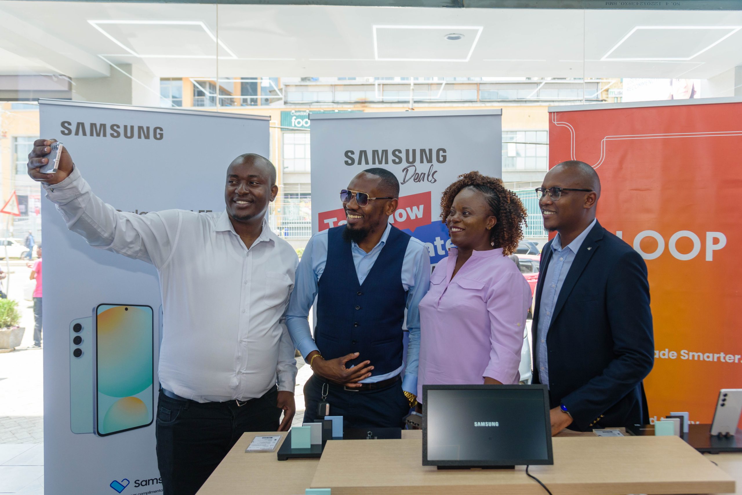 Samuel Kamau, Entrepreneur and official Samsung dealer, Galaxy Mobiles (second left), in a group selfie with David Kinuthia, Head of Marketing at BuySimu, Elizabeth Mudogo, Head of Ecosystems at Loop, and George Kebaso, Head of EIP Business Mobile Experience at Samsung Electronics East Africa, during the launch of the new Samsung S24 FE into the Kenyan Market on Thursday, 24th October 2024, at Shujaa Mall in Kilimani, Nairobi.